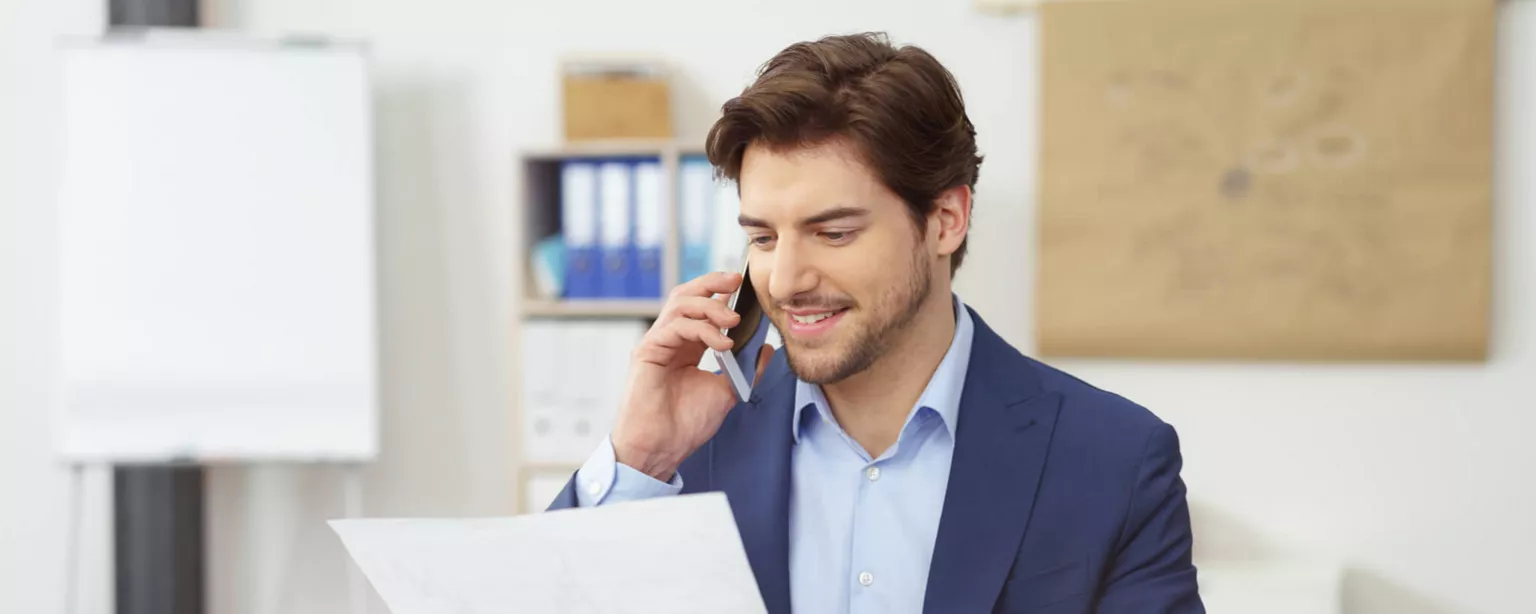 How to Become an Accountant: A 6-Step Plan — man with phone looking at document