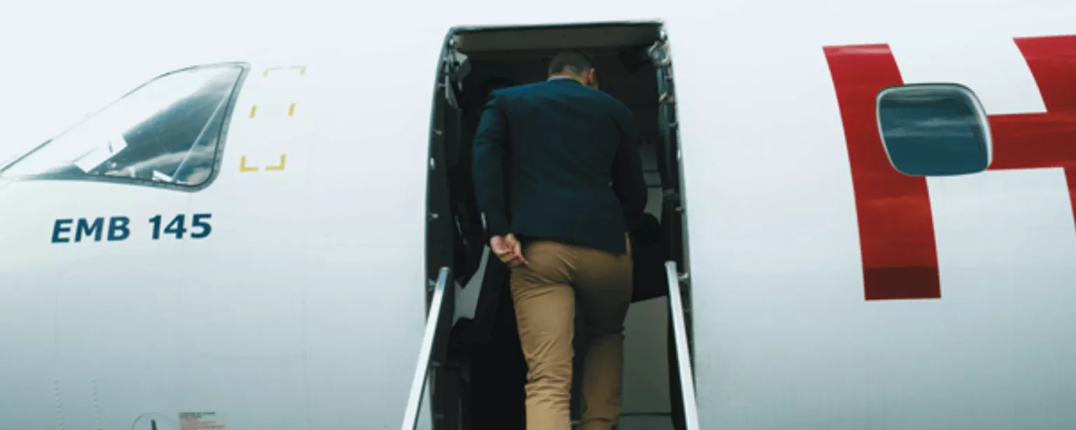 Mann steigt im Flugzeug ein, Urlaub ist zu Ende