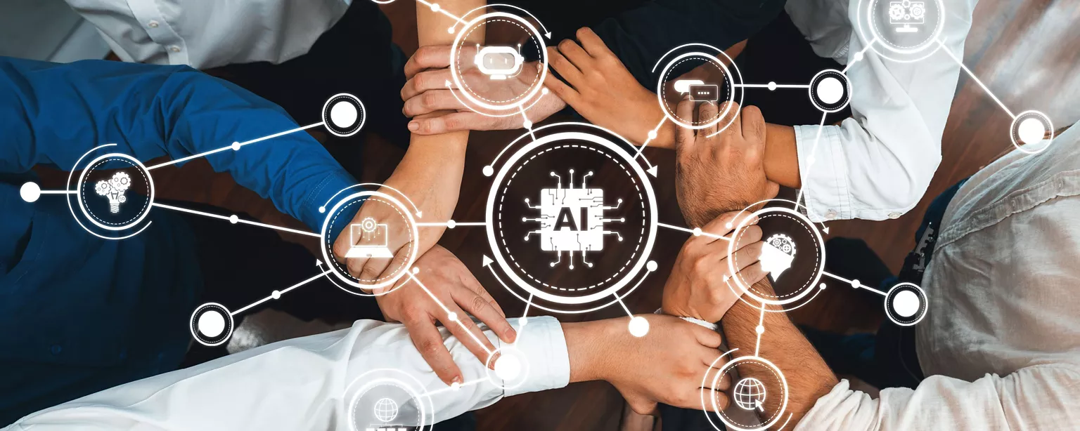 Diverse team working together with hands united over technology icons.