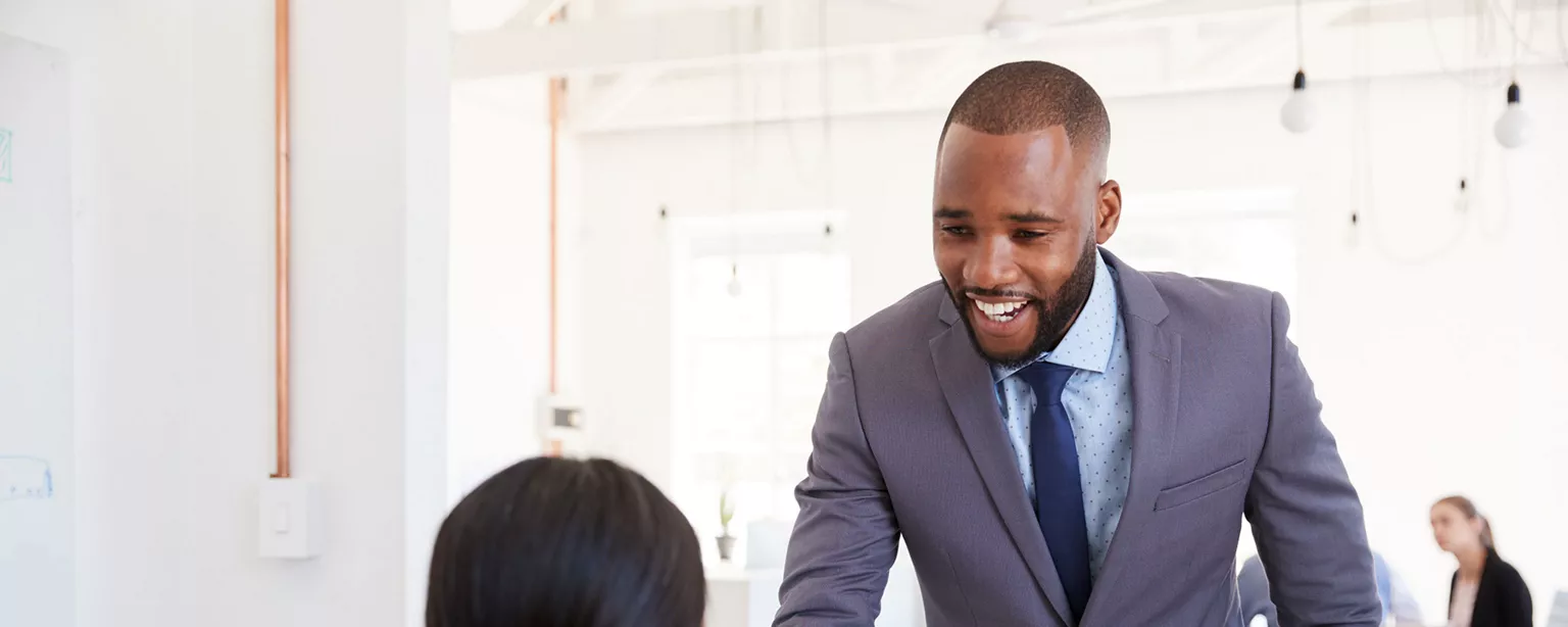 Young professional man shaking hands with a woman.
