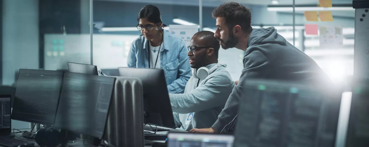 A tech and IT leader shares a project plan on his computer screen as they work together on a digital transformation project for the company.