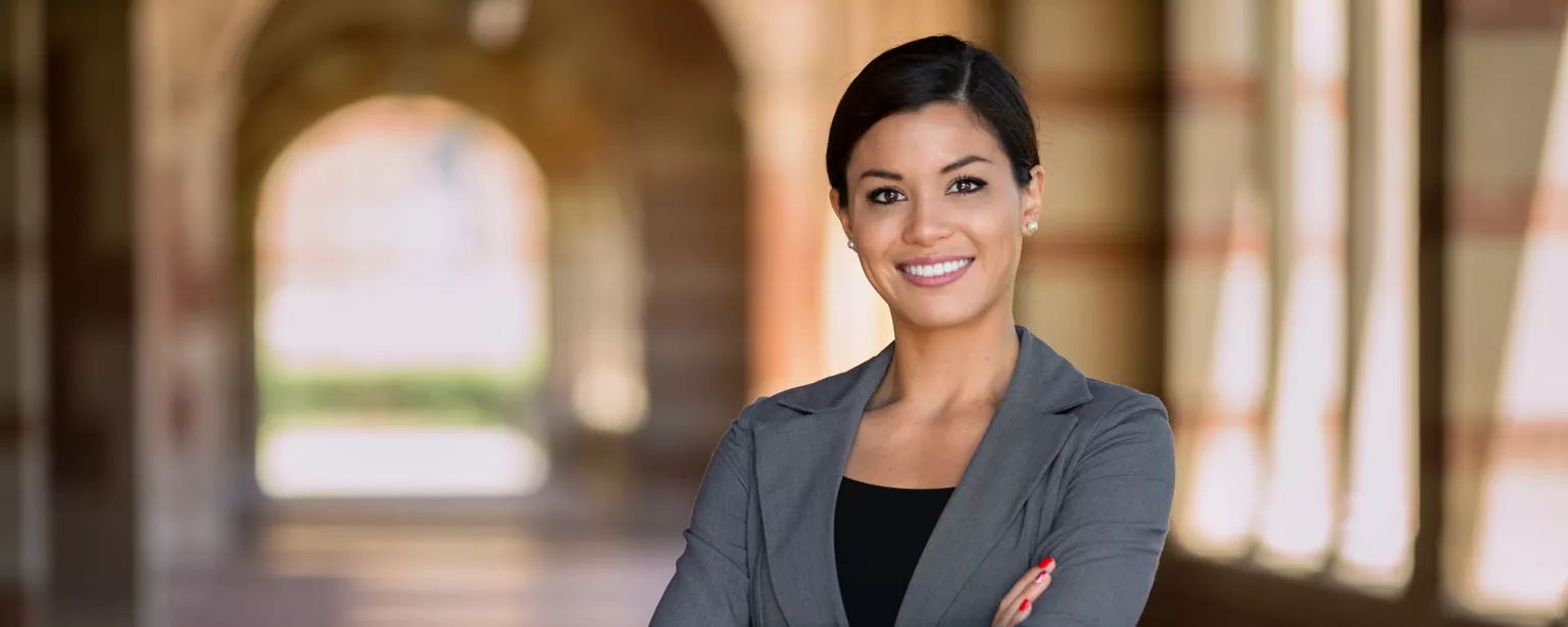Reap the Benefits of Being Your Own Boss With Contract Lawyer Work — smiling woman standing with her arms crossed