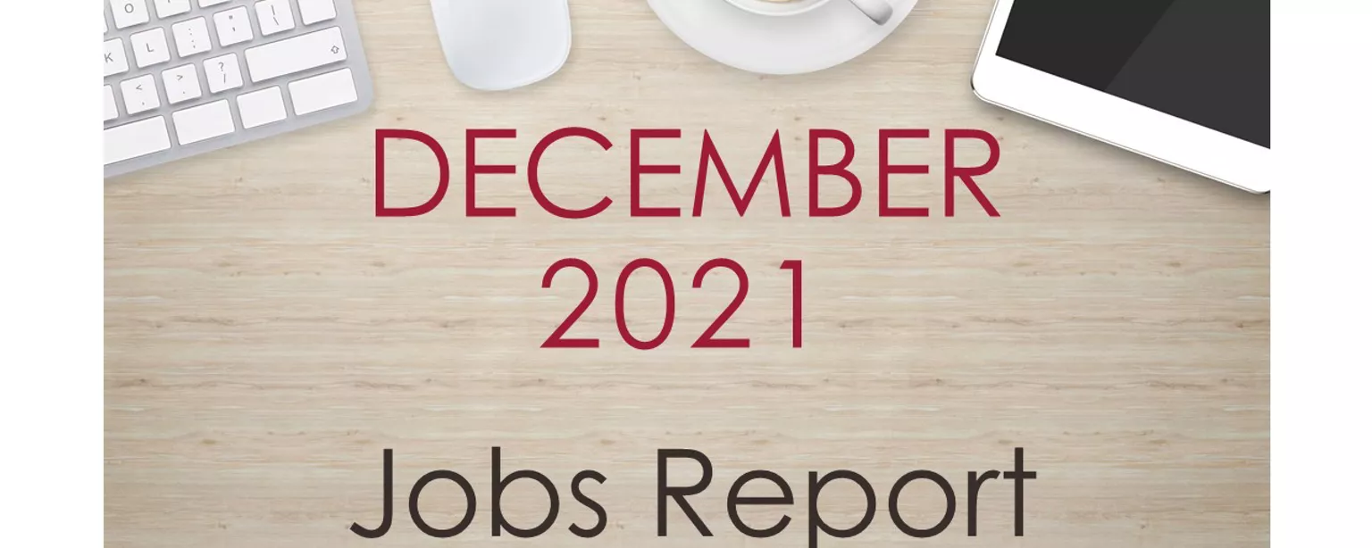 Desktop with keyboard, tablet and coffee cup, with text that reads: December 2021 Jobs Report