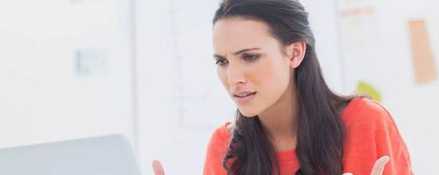 Woman throwing up her hands as if she's annoyed by email issues