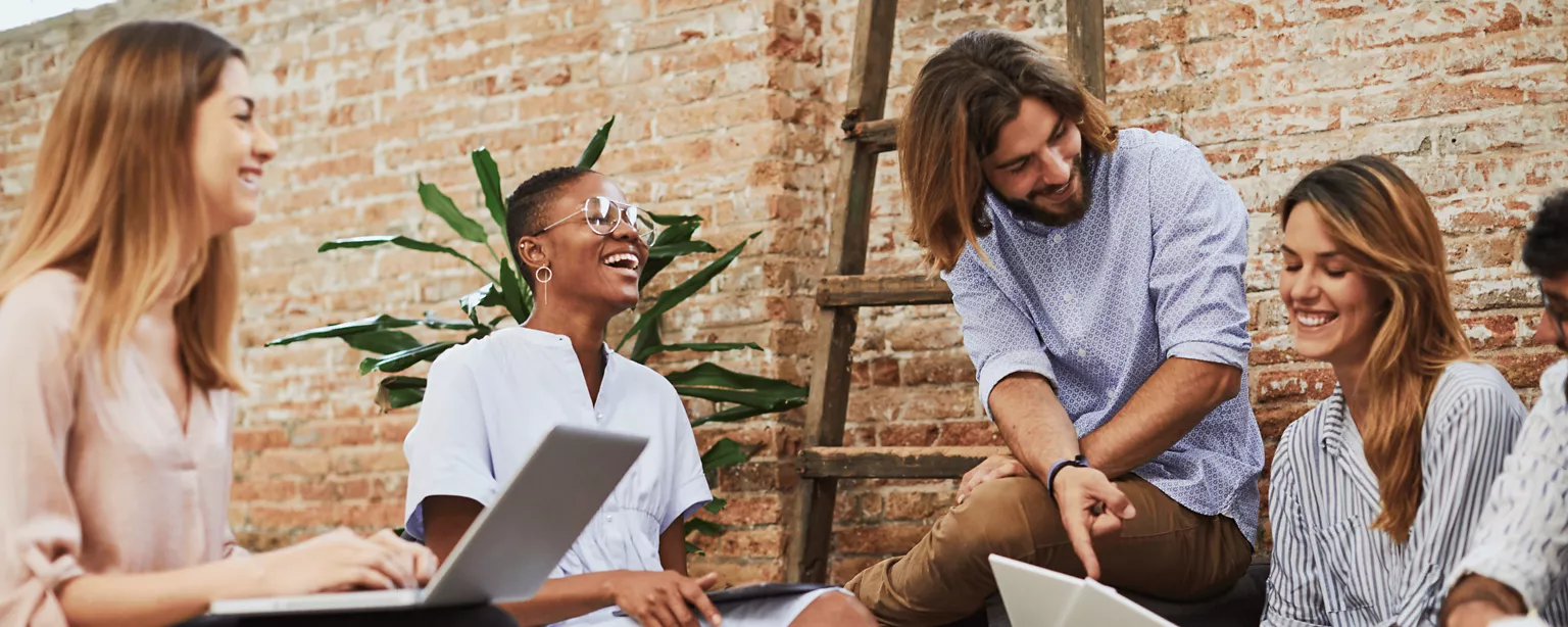Employees sitting desk around talking