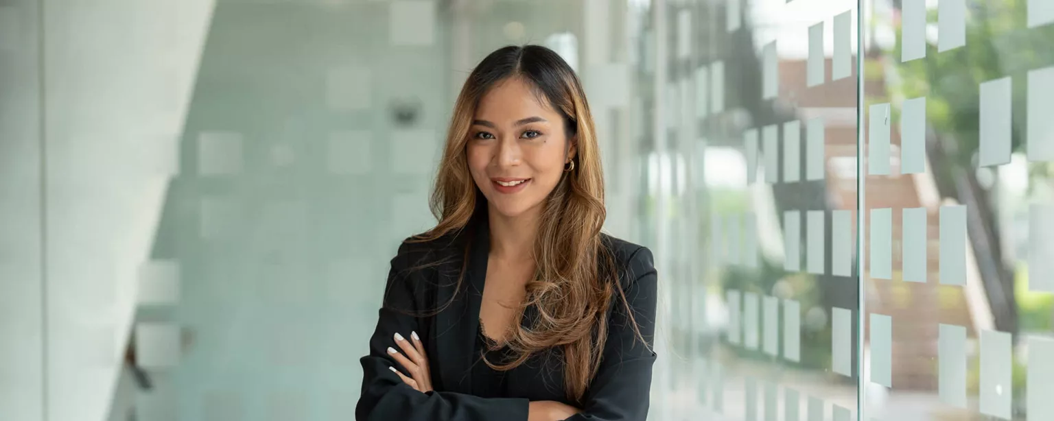 Evaluating Top Executive Search Firms — woman in professional office standing at desk