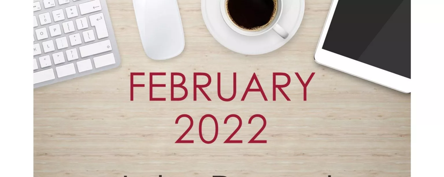 Desktop with keyboard, tablet and coffee cup, with text that reads: February 2022 Jobs Report