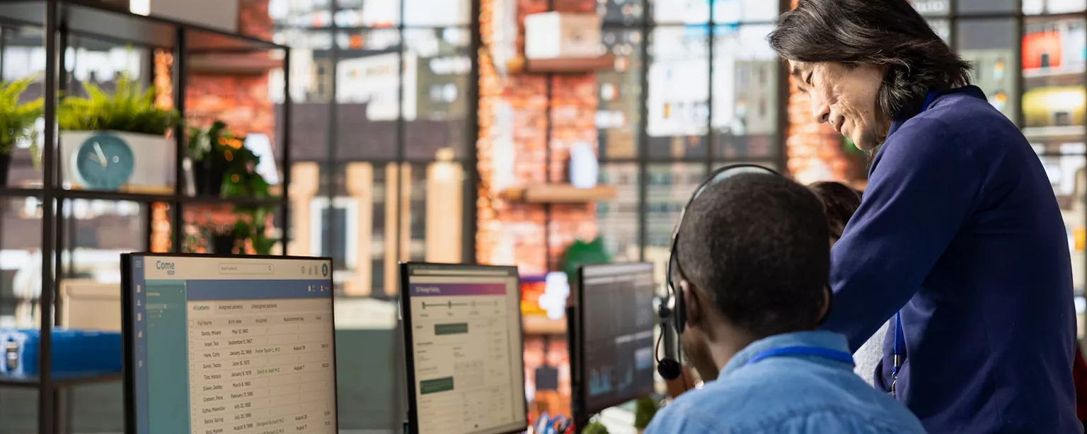 Customer support personnel looking at computers and tracking shipments.