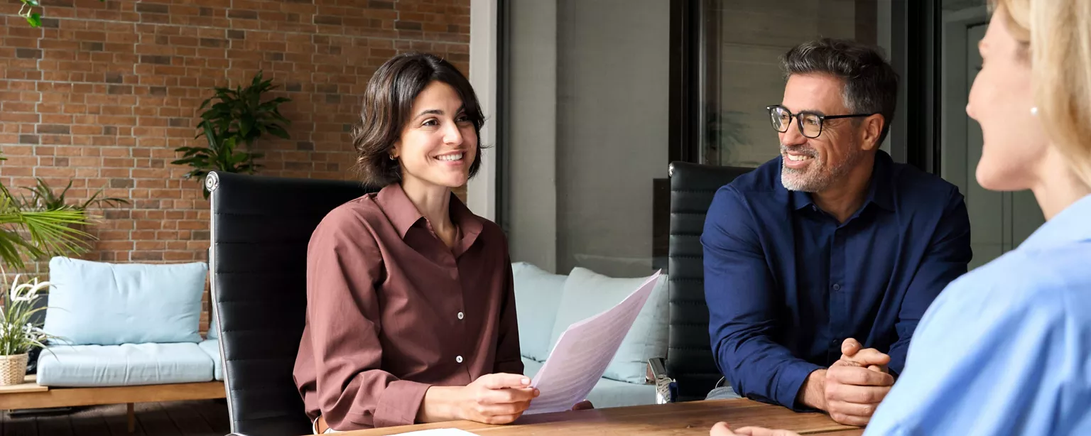 Happy female and male corporate executive HR team meeting with a potential female employee.