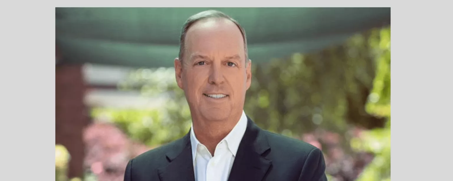 Greg Scileppi, president of international staffing operations for Robert Half, smiling and wearing a dark blazer and white shirt in an outdoor setting.
