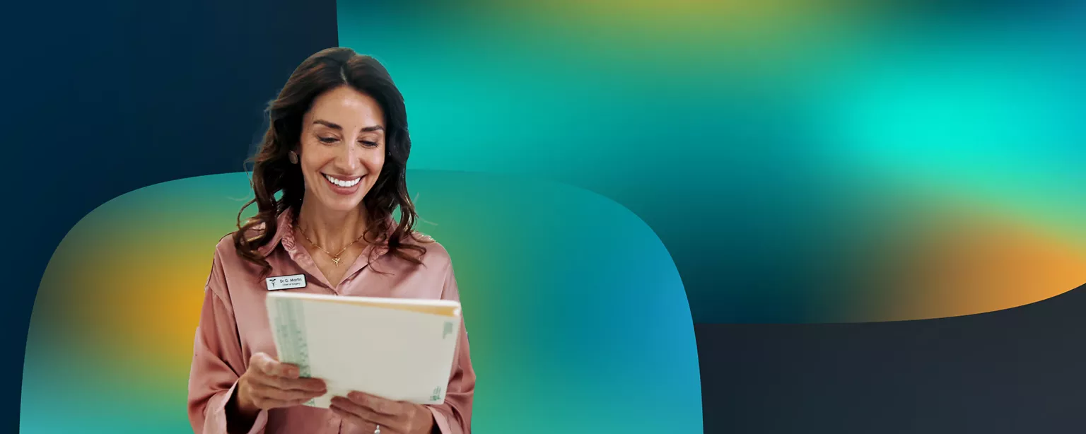 Woman smiling and looking at medical files.