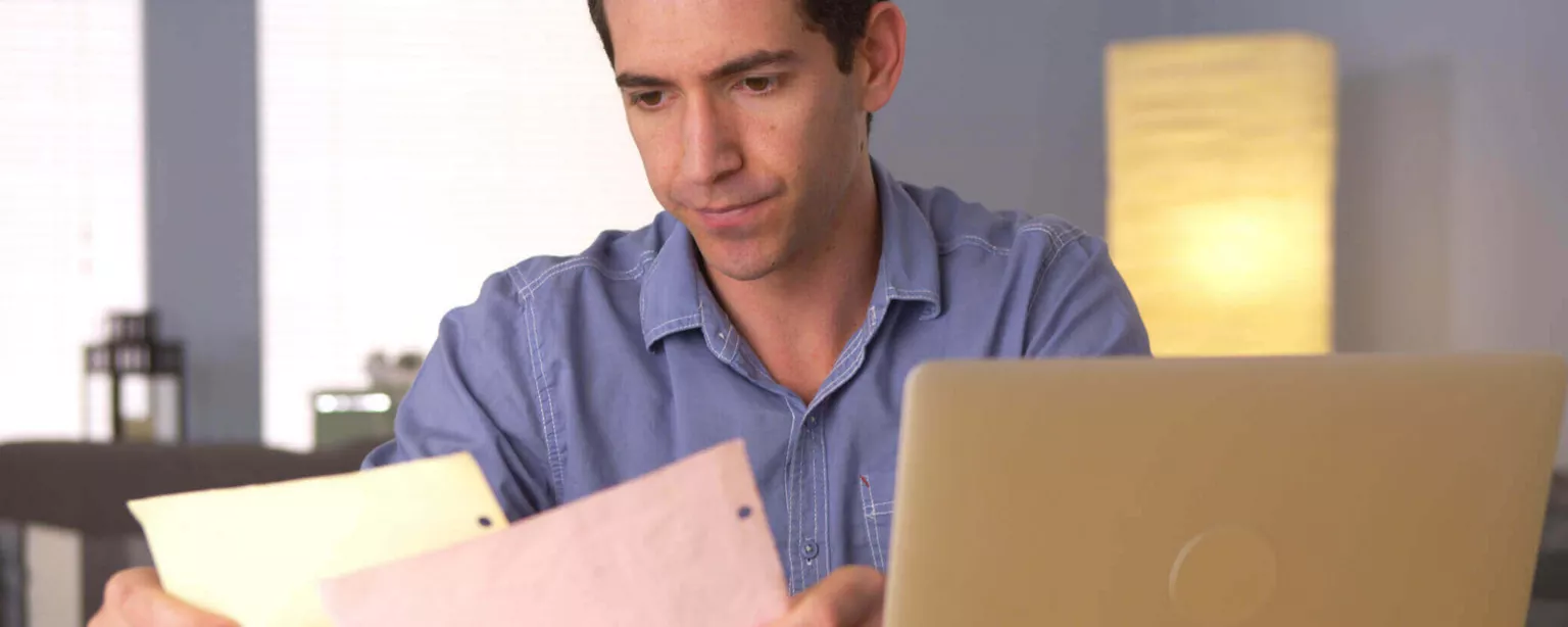 Business owner at laptop who wishes he was hiring accounting staff
