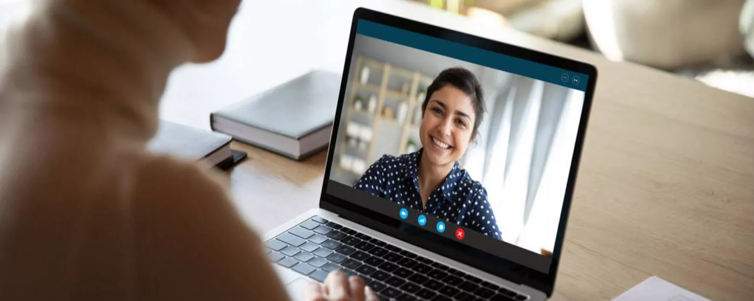 How to Hire Customer Service Specialists - woman talking to smiling woman on laptop screen