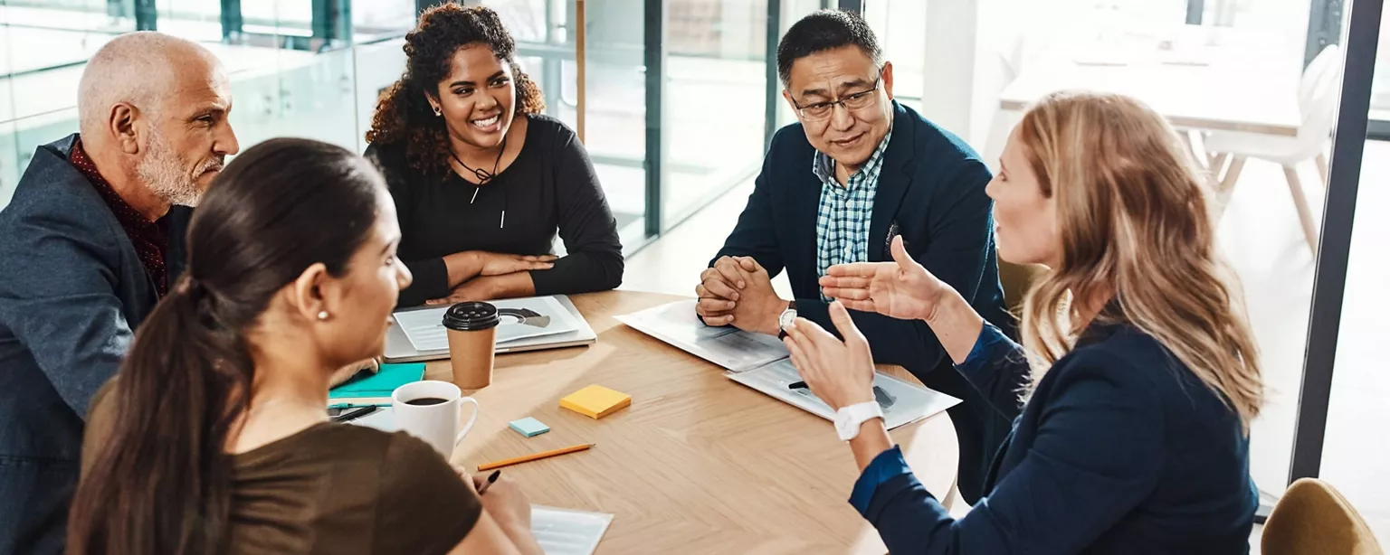 A job candidate talks about her career experience during a panel interview.