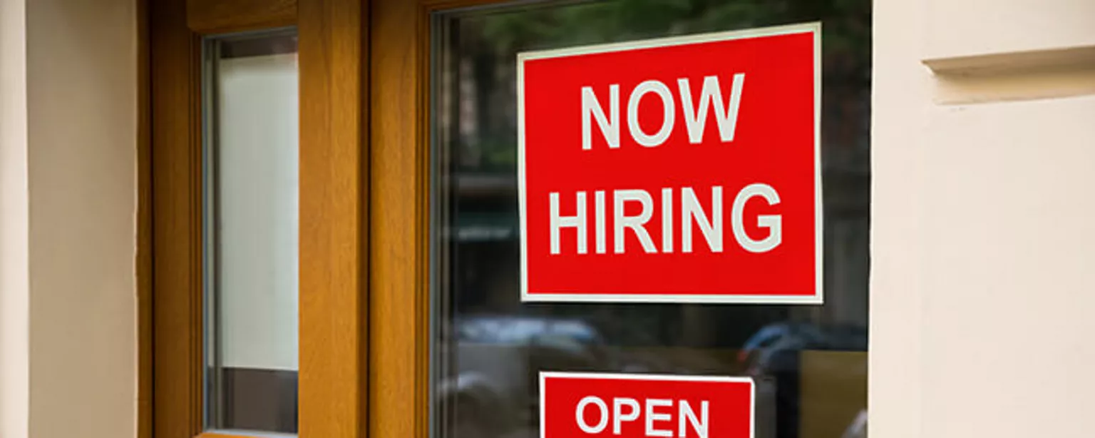 Now Hiring sign on door may not attract someone job hunting these days