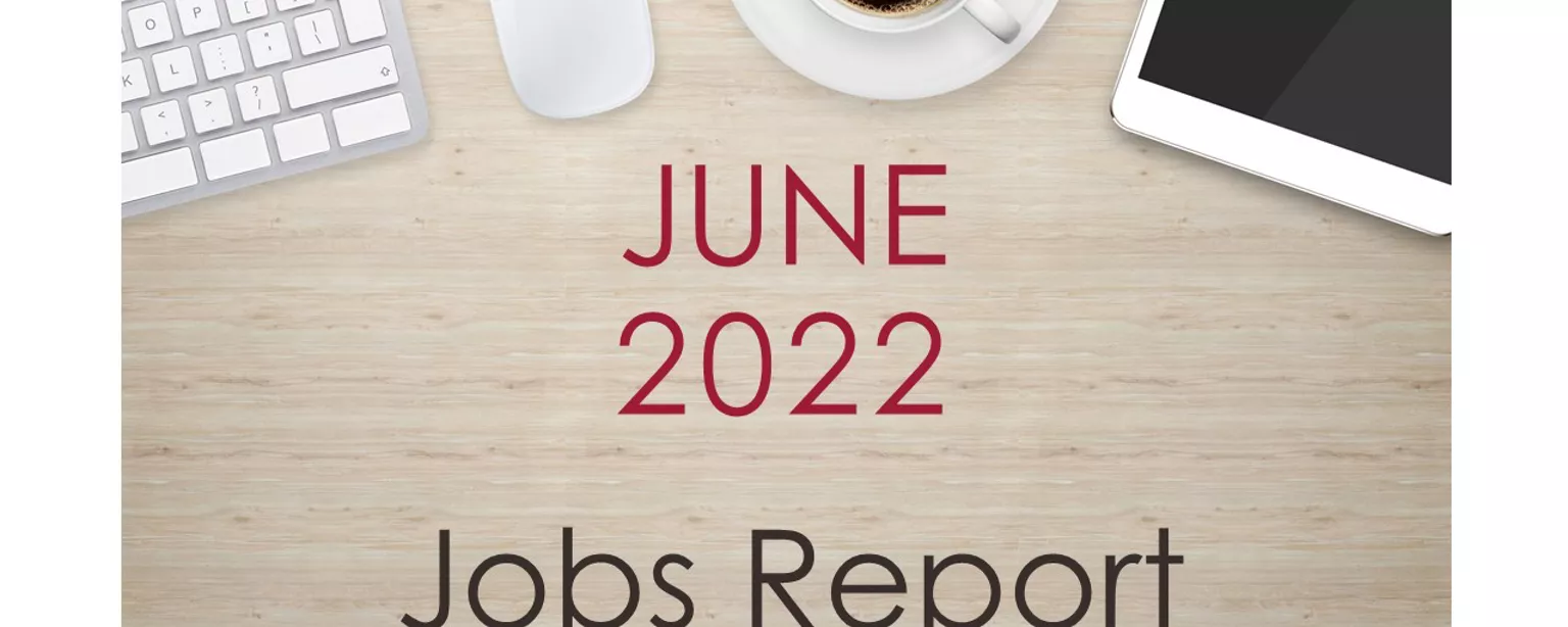Desktop with keyboard, tablet and coffee cup, with text that reads: "June 2022 Jobs Report."