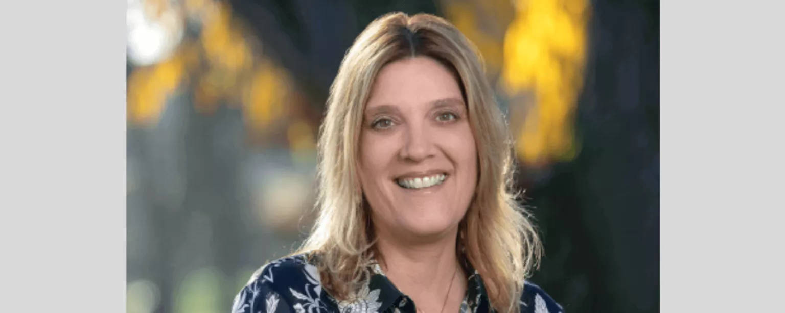 Lynne Smith, SVP of Global Human Resources at Robert Half, smiling in an outdoor setting.