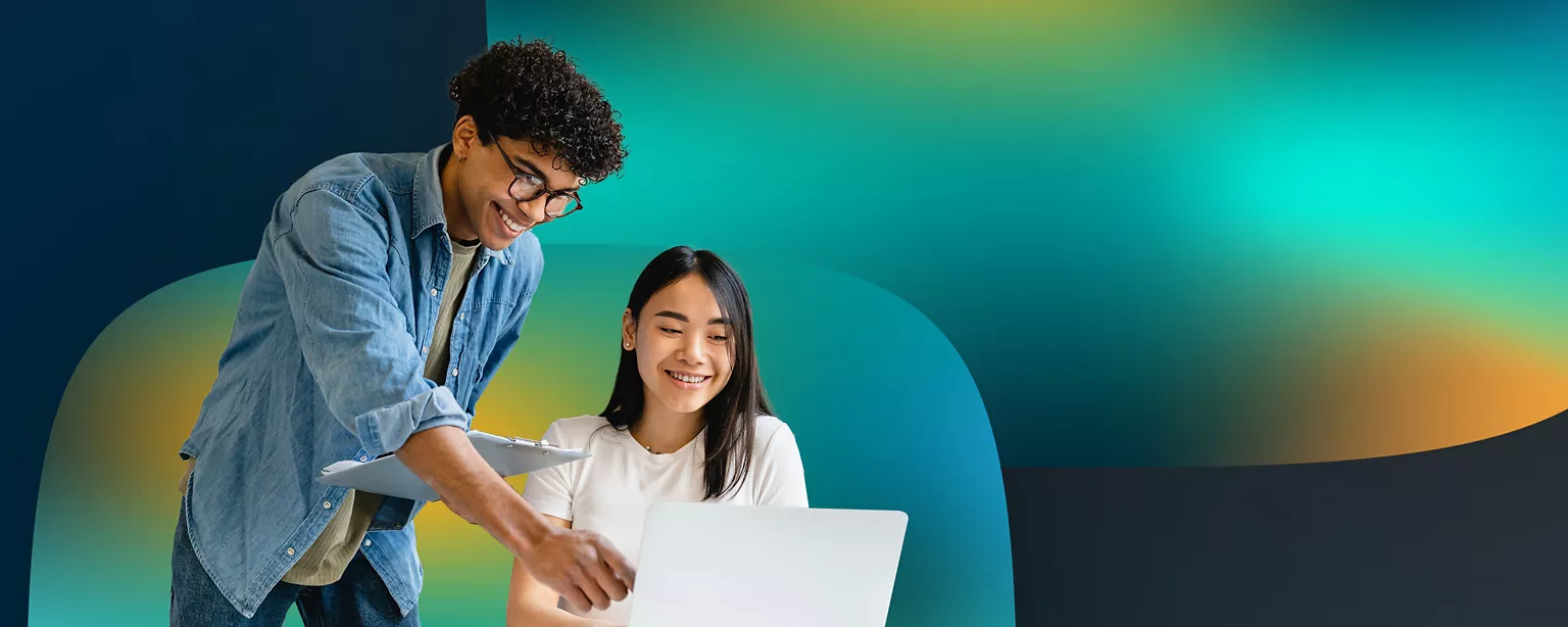 A marketing professional reviews a project with a colleague while collaborating against a colorful gradient background.