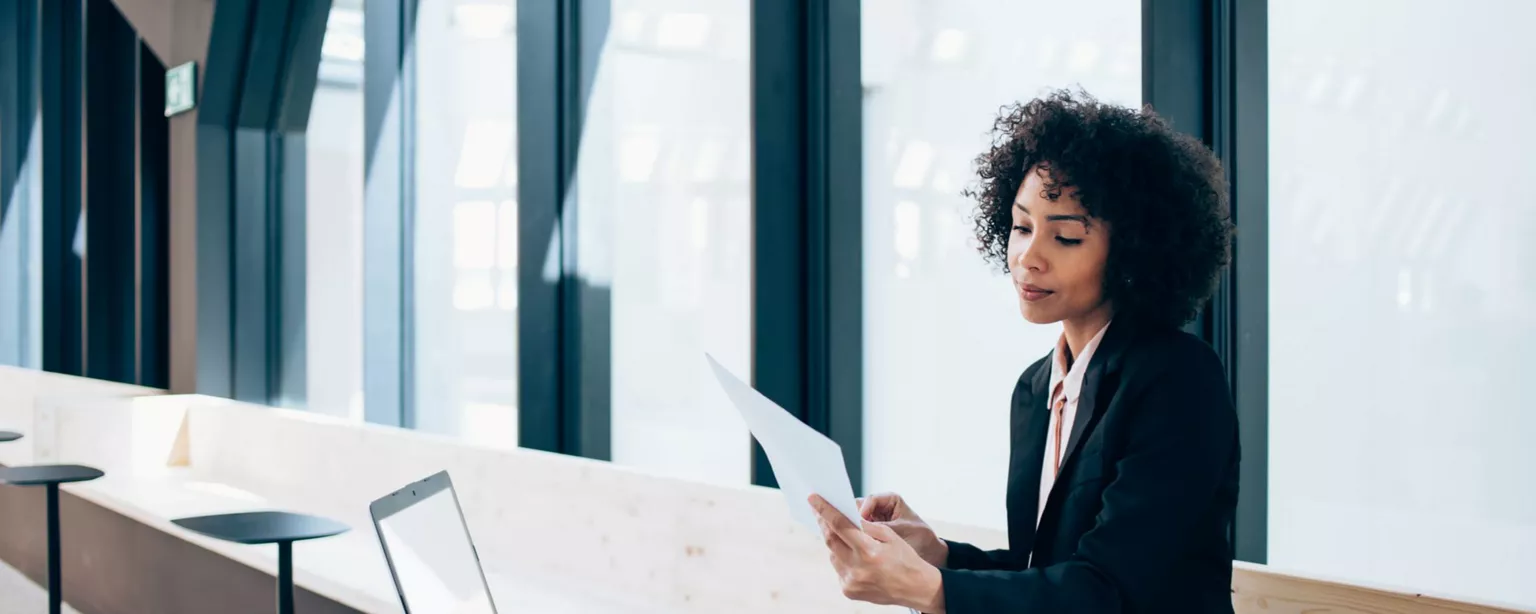 Nontraditional Jobs in the Legal Field Offer Diverse Options — woman attorney in a business suit looking at paperwork in preparation for a case