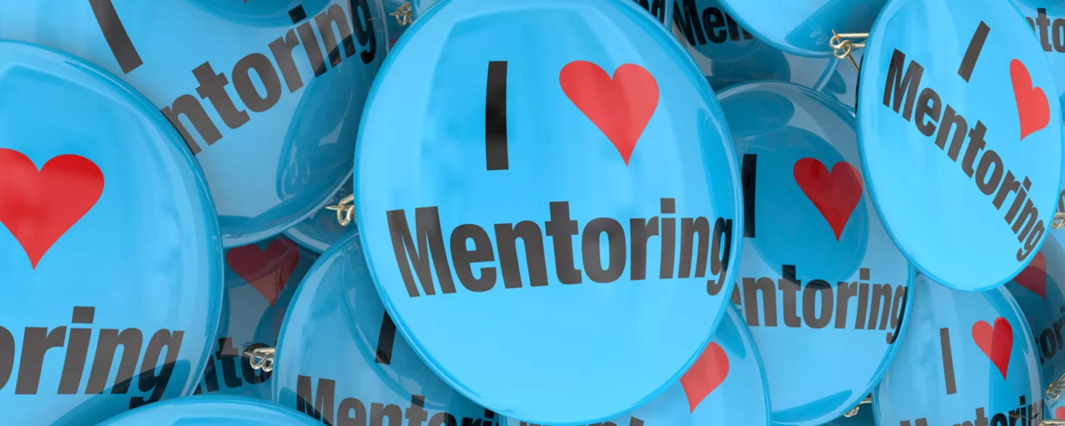 A pile of blue buttons that say, "I love mentoring."