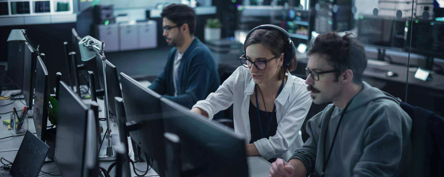 A technology manager mentors a colleague who is learning new coding skills.