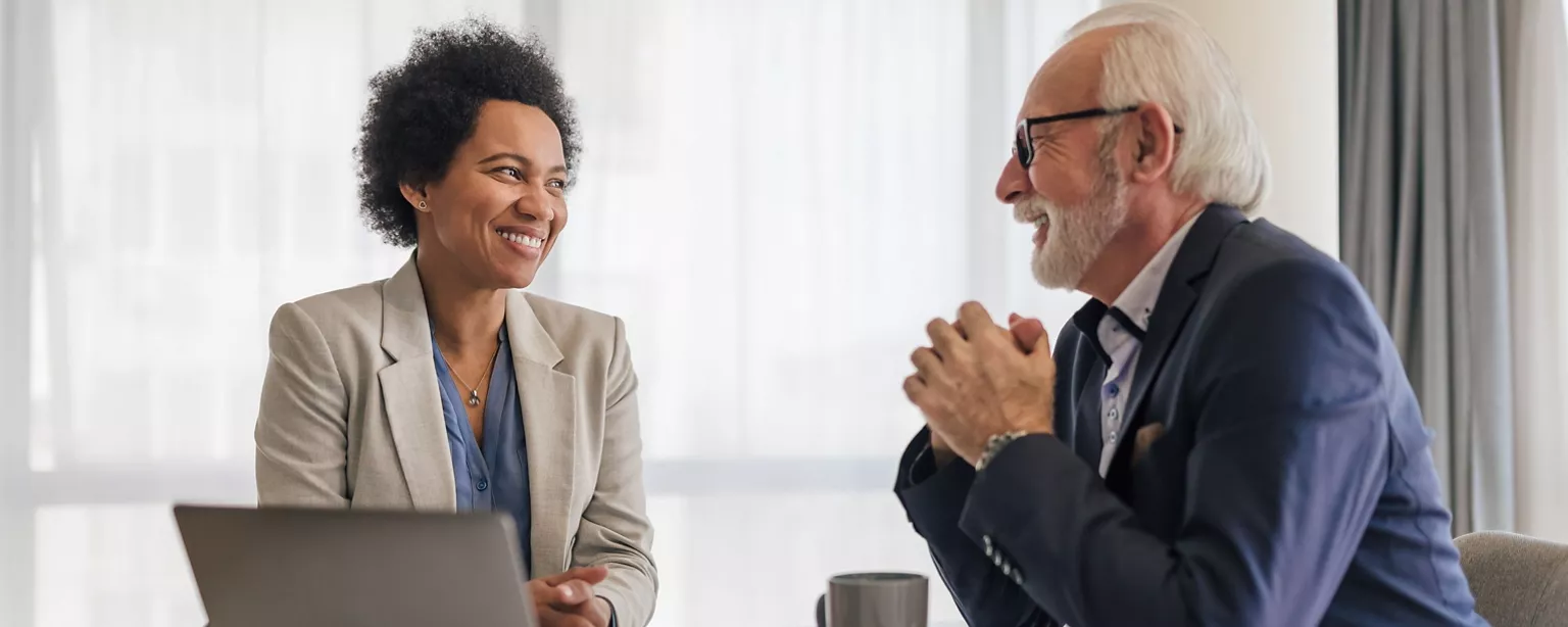 A leader of a small businesses discusses a succession plan opportunity with a star employee.
