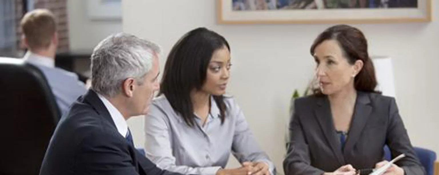 Finance professionals sitting at table like this have effective meetings 