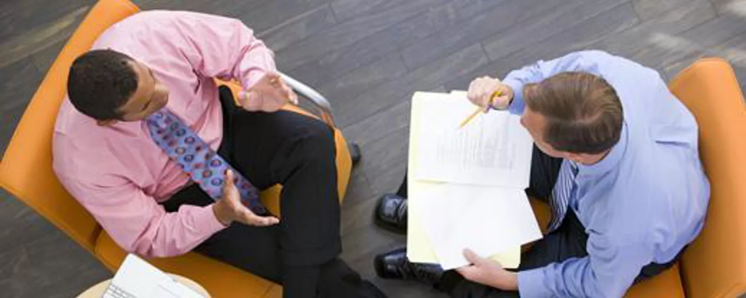Shot from above of two businessmen talking, possibly about Sarbanes-Oxley compliance