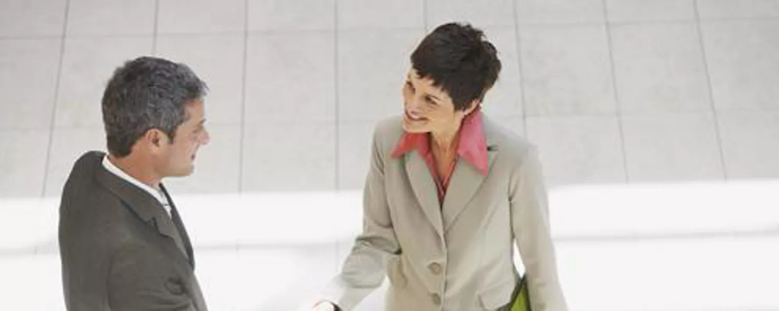 Professional man and woman shaking hands and using the elevator pitch