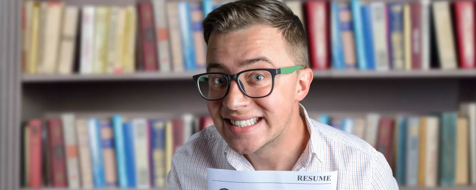 Resumania®: Keep Salary Requirements Out of Your Resume — man holding resume with a funny look on his face