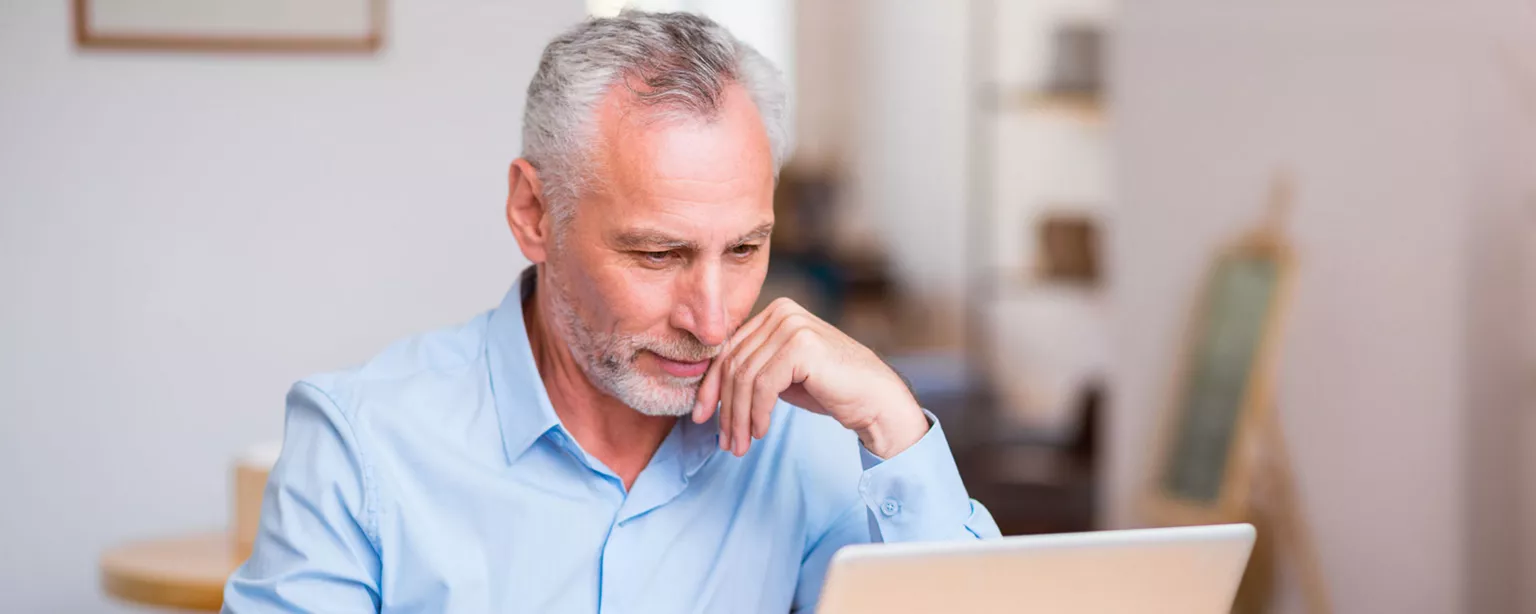 Best Advice for Retired Accountants Who Want to Work — Gray-haired man working at laptop