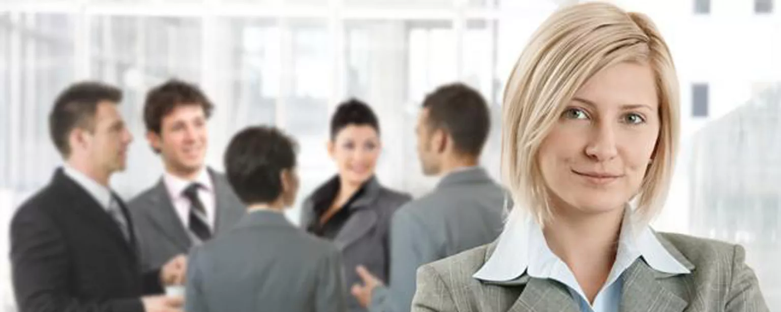 Woman in front of group of professionals as she considers her senior accountant salary