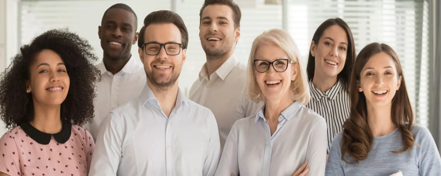 Group of smiling business people of all ages, genders and ethnic backgrounds.