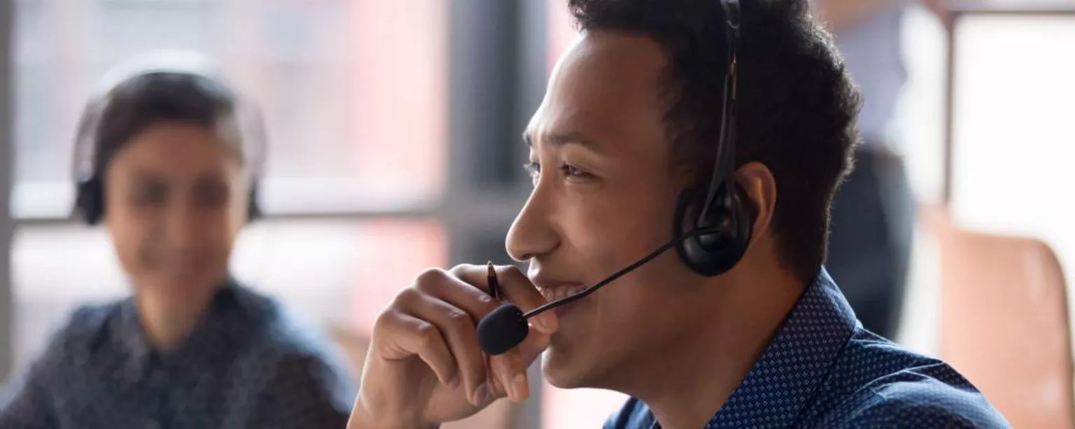 All You Need to Know About Customer Service Jobs - Smiling young businessman talking on headset