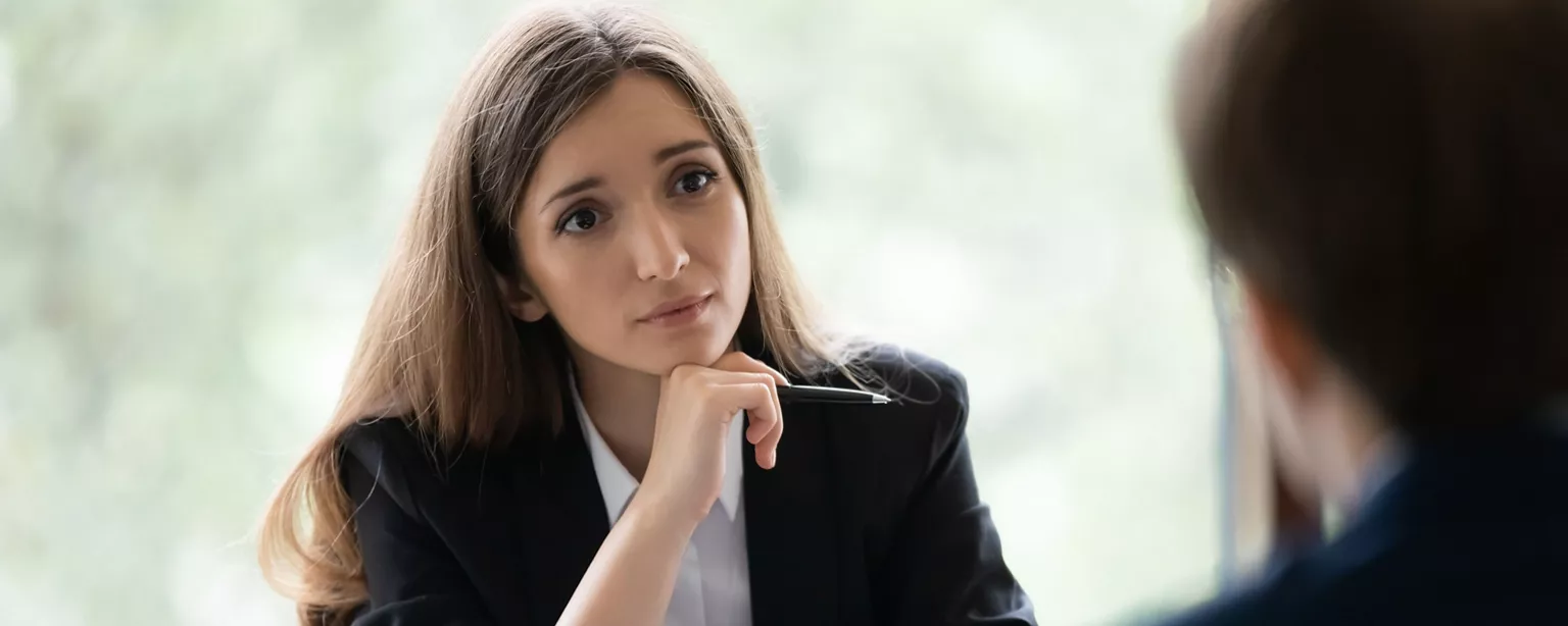 A female manager listens sympathetically as an employee informs her she will be leaving her job.