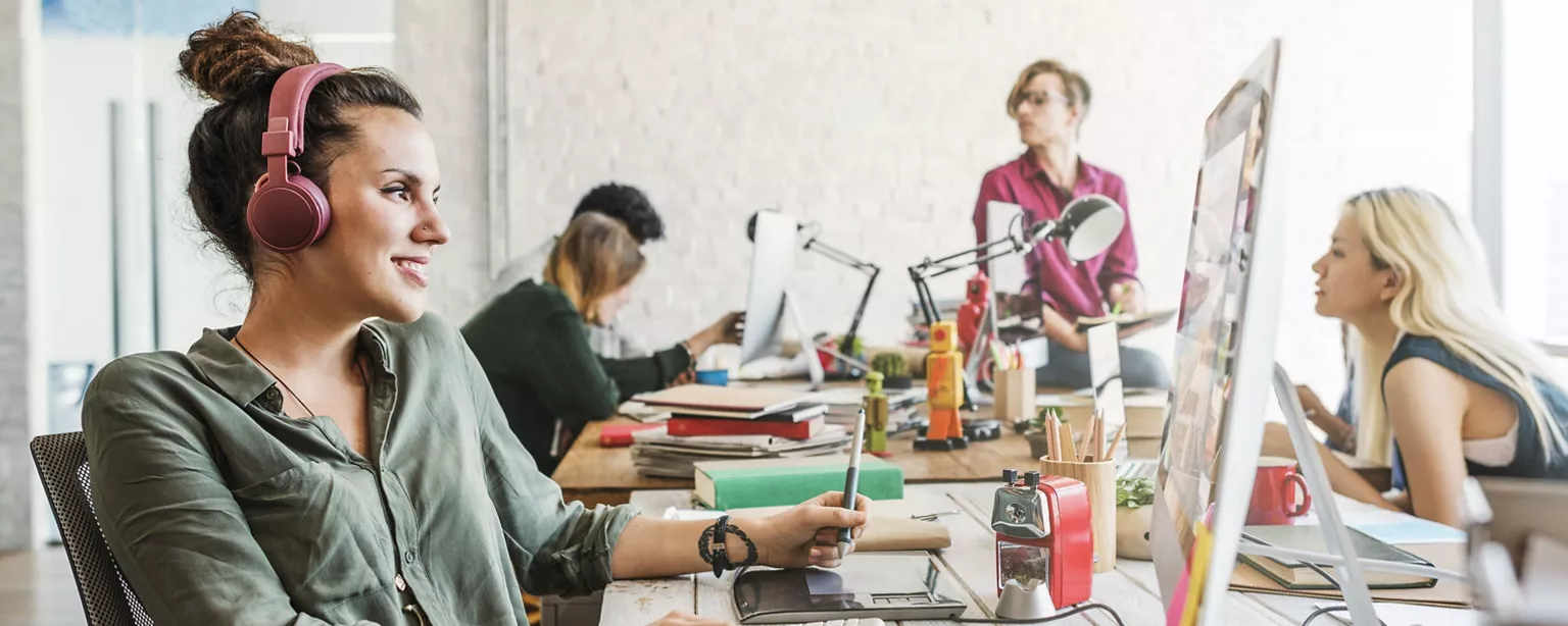 Male and female business team brainstorming workspace.