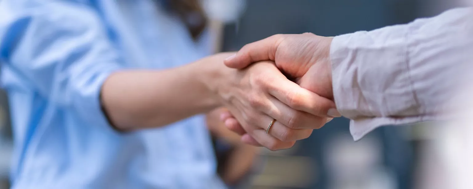Two people shaking hands.
