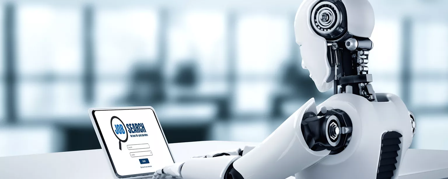 AI robot sitting at a laptop looking up jobs to apply for.