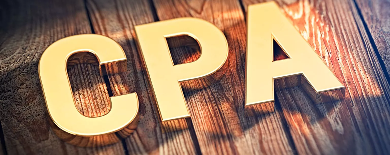 The acronym "CPA" in gold letters set against a wooden floor background.