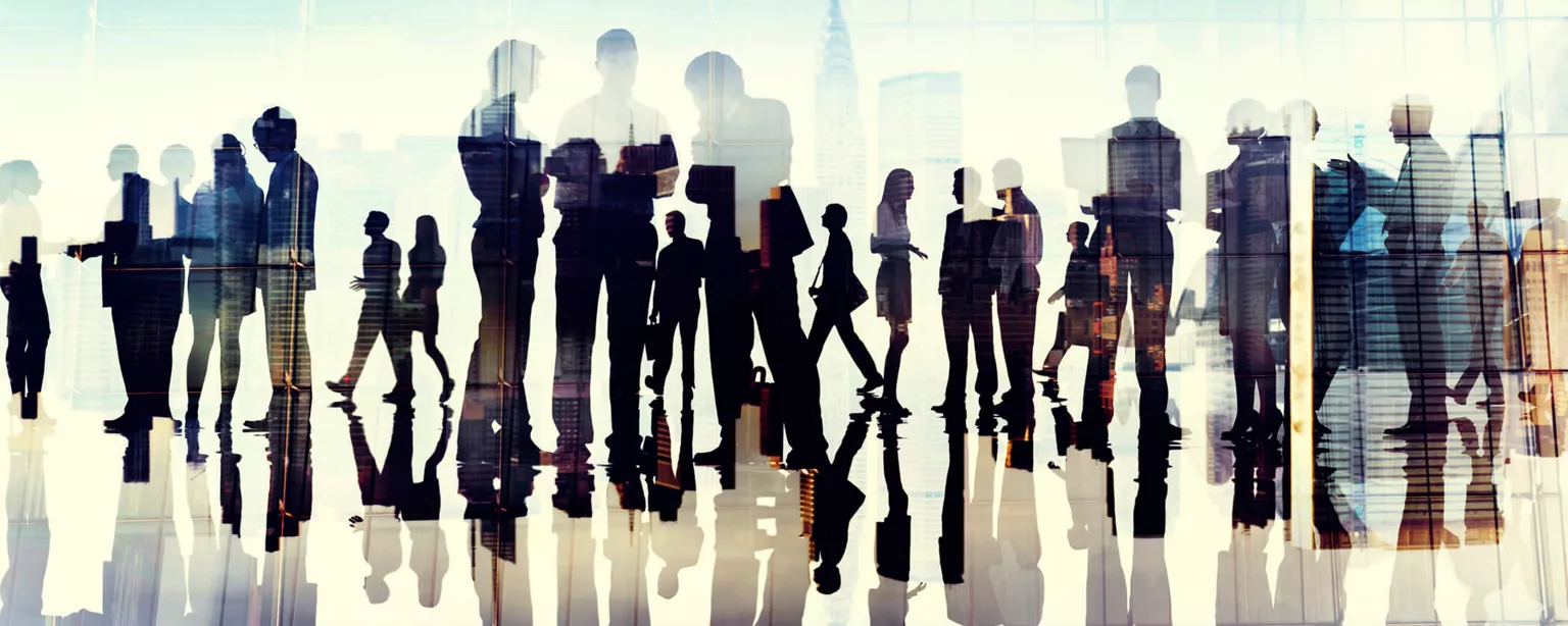Silhouettes of business people networking at a C-suite conference 