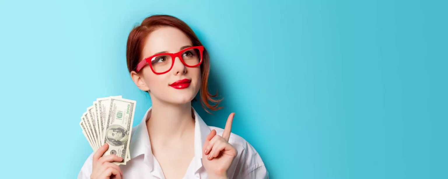 Young woman with red glasses holding money.