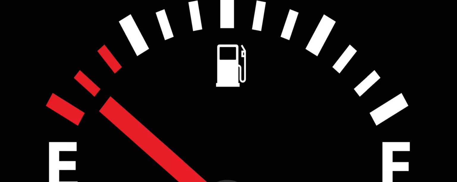 Fuel gauge for a vehicle, with a red line pointing toward "Empty."