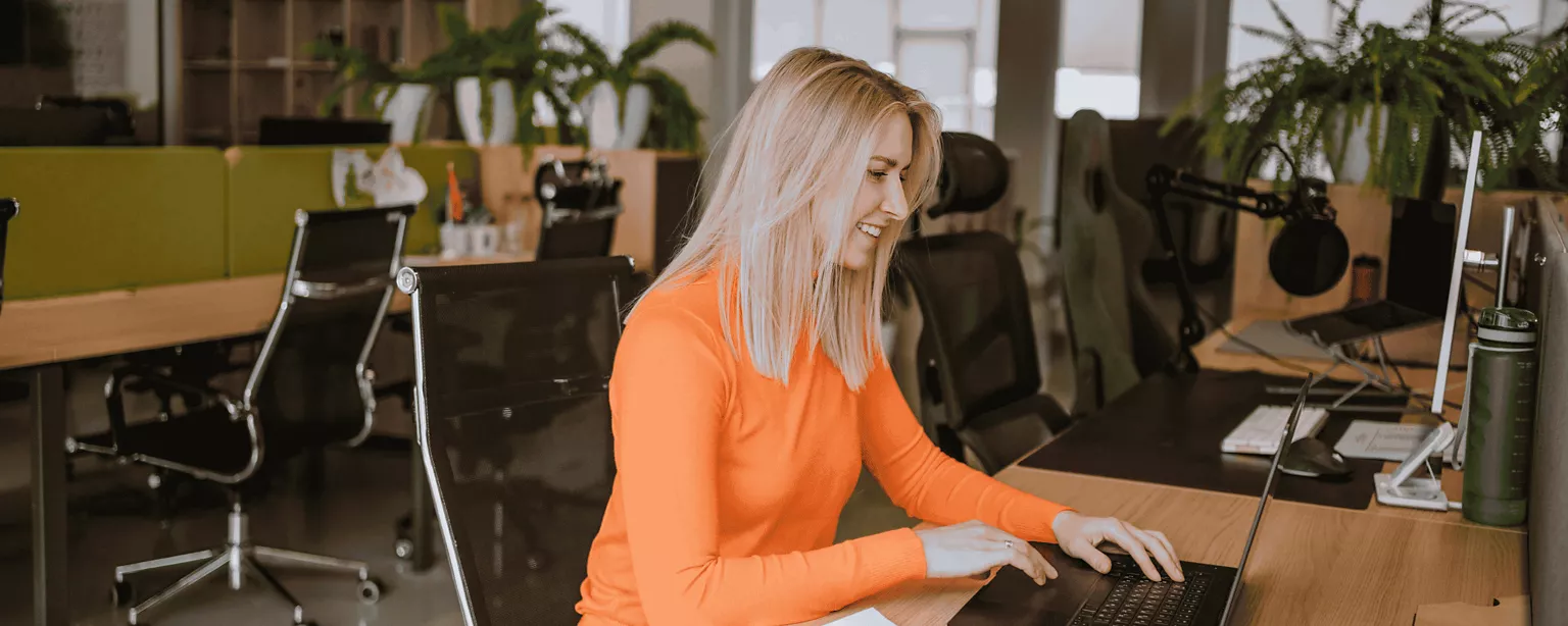 A woman works at a desk