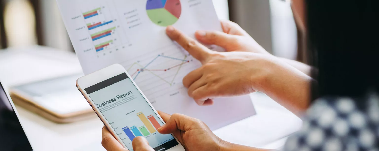 Two people working with graphs showing what you can do with an accounting degree