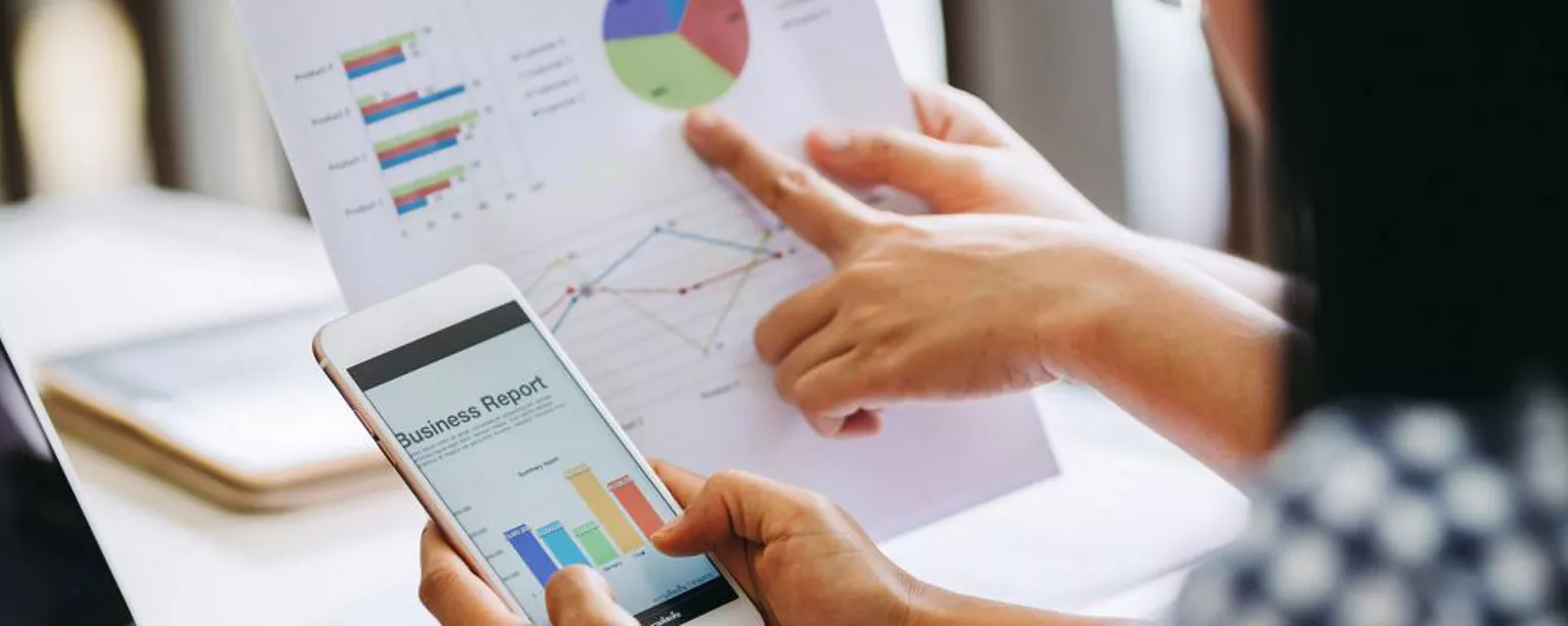 What Jobs Can You Get With an Accounting Degree - Two people working with graphs showing what you can do with an accounting degree