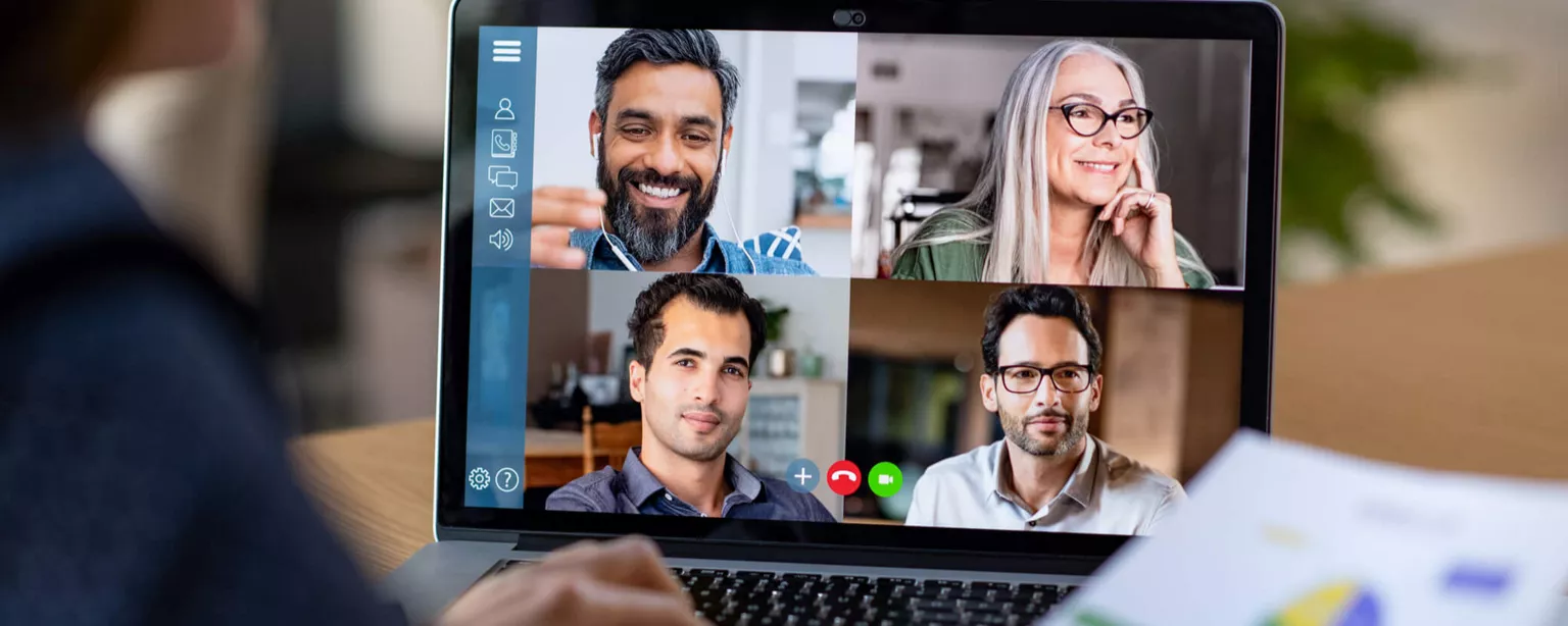 Working From a Distance — person holding a sheet with a pie chart teleconferences with four remote workers