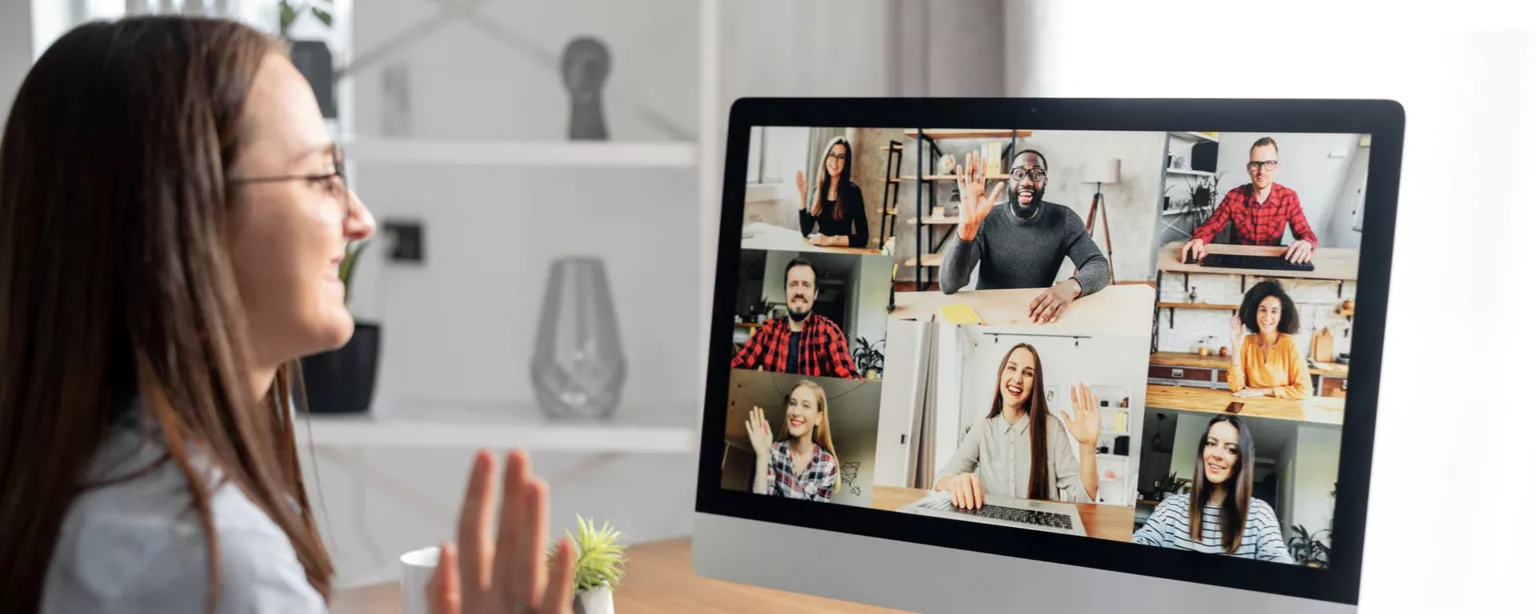 A remote worker on a video call, meeting her new teammates.