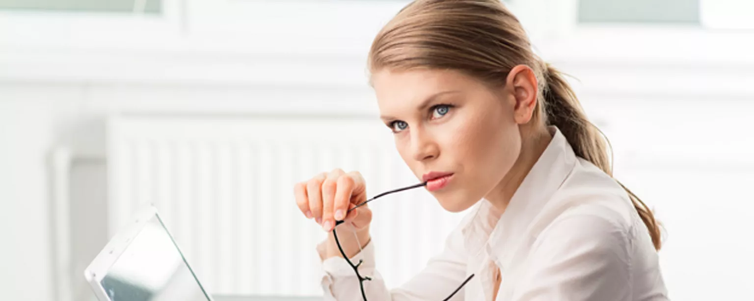 Woman at laptop contemplating her accounting clerk salary