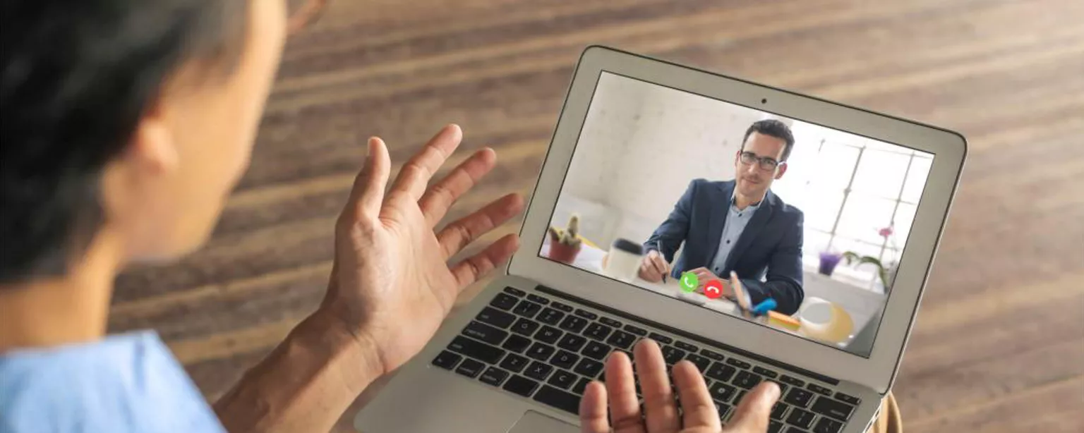 Why You Need to Ask These 21 Accounting Interview Questions — person talking remotely on laptop