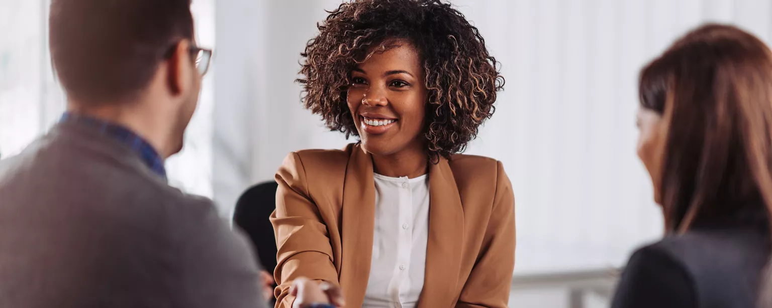 A candidate for an executive position shakes hands with the interviewer during one of several discussions about the role.